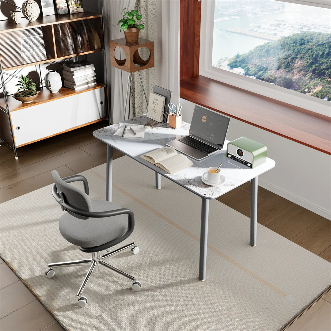 Modern home office with a desk, chair, and laptop in a well-lit room.