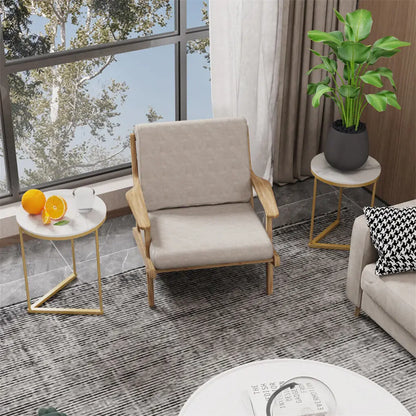 Modern living room with a beige armchair, side tables, and a plant.