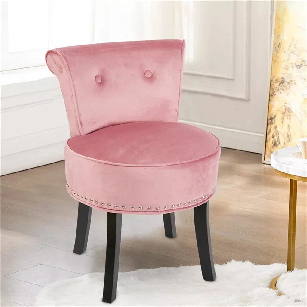 Pink velvet chair with black legs in a room setting