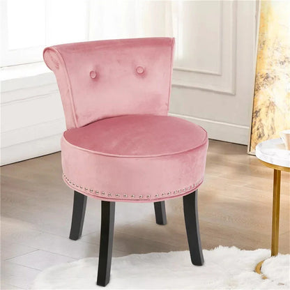Pink velvet chair with black legs in a room setting