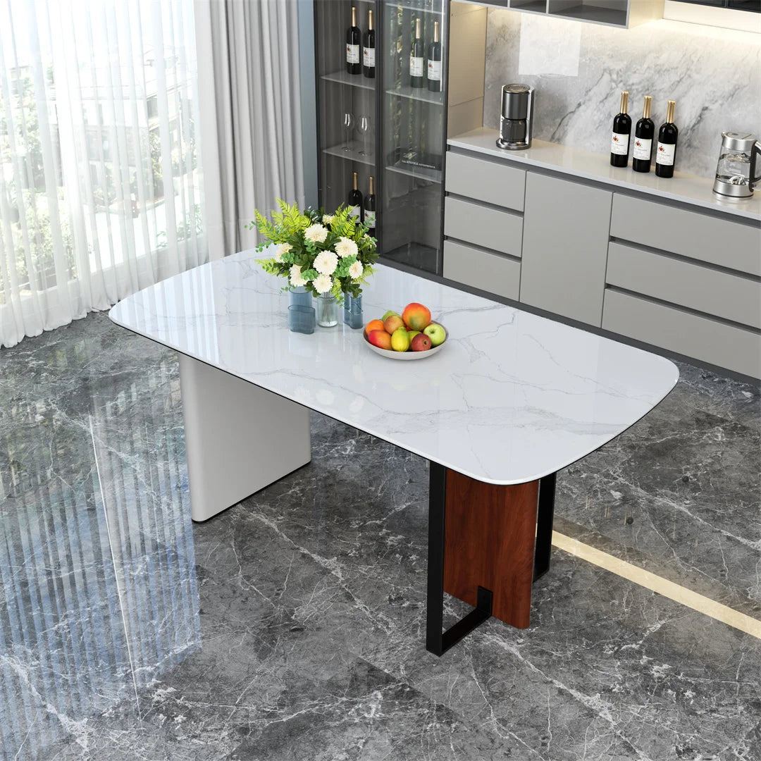 Modern dining table with a white marble top and wooden legs in a kitchen setting.