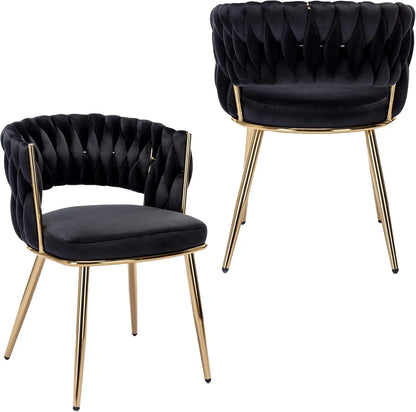 Two black tufted chairs with gold legs on a white background