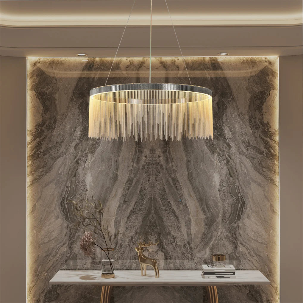 Chandelier hanging above a marble wall with decorative items.