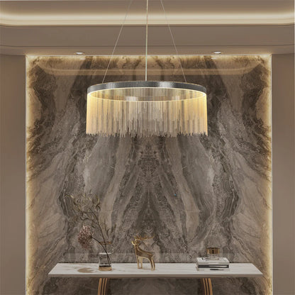 Chandelier hanging above a marble wall with decorative items.
