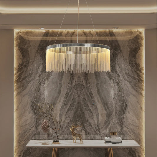 Chandelier hanging above a marble wall with decorative items.