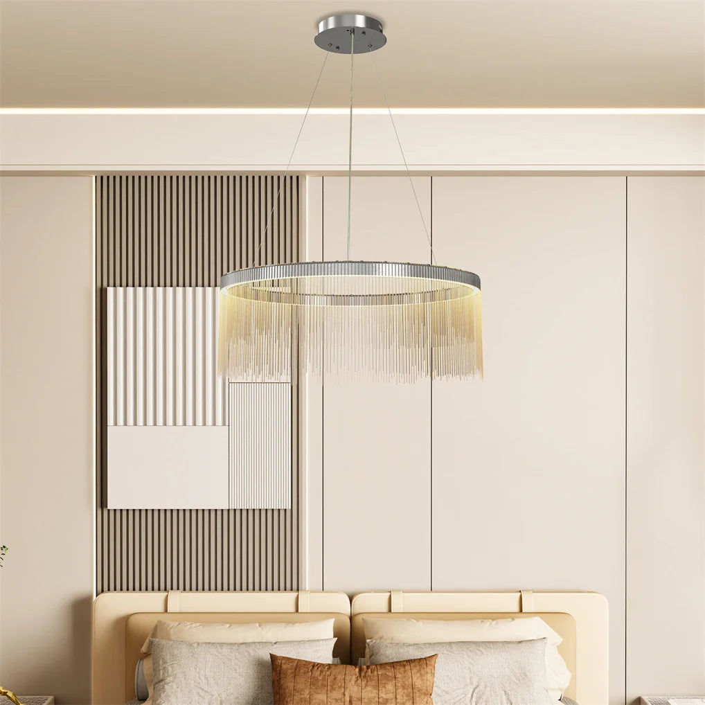 Modern chandelier hanging above a sofa in a living room setting.