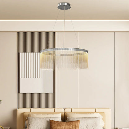 Modern chandelier hanging above a sofa in a living room setting.