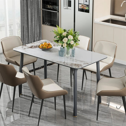 Modern dining room with a glass table and chairs in a kitchen setting