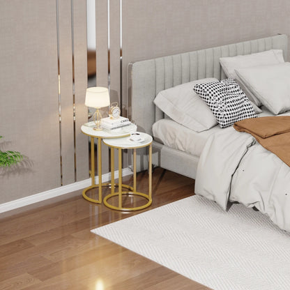 Modern bedroom with a bed, side tables, and decor items.