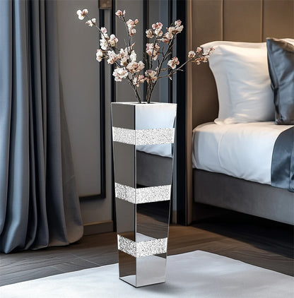 Decorative mirrored vase with floral arrangement in a bedroom setting