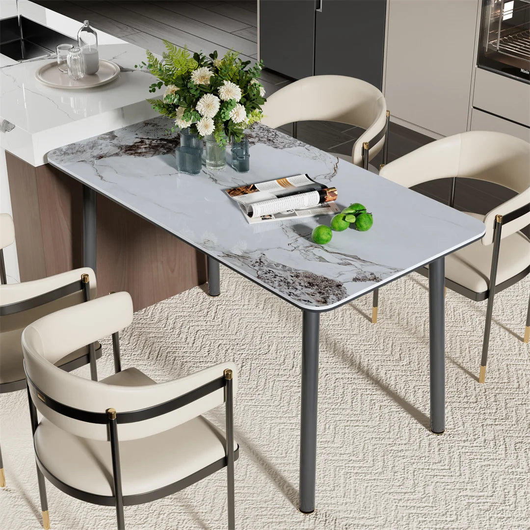 Dining table with marble-like surface and chairs in a modern kitchen setting