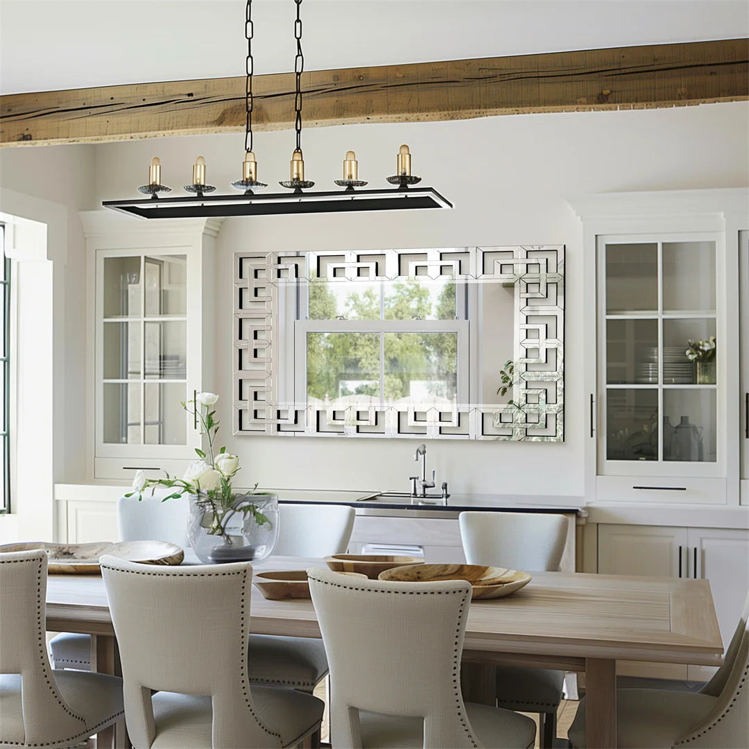 Modern kitchen with wooden dining table, chairs, and decorative mirror.