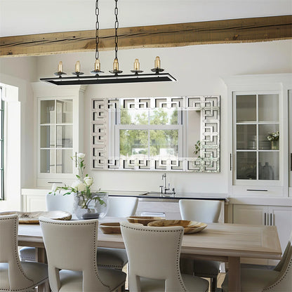 Modern kitchen with wooden dining table, chairs, and decorative mirror.