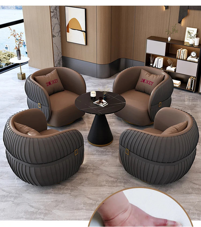Modern living room with brown armchairs and a round table.