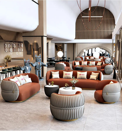 Modern interior design with brown sofas, gray chairs, and decorative elements.