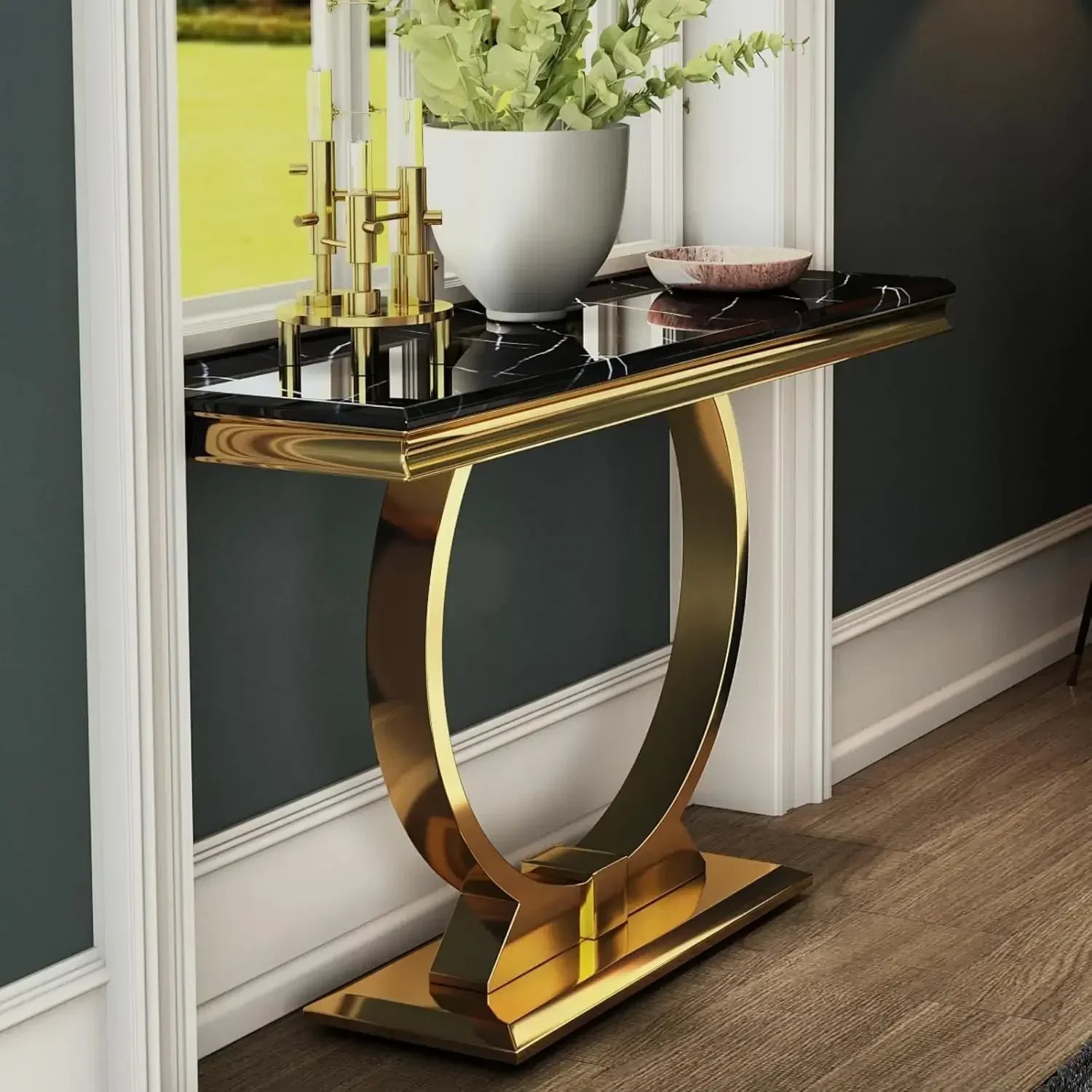 Gold console table with black marble top in a room setting