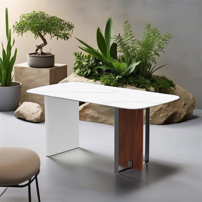 Modern white table with wooden leg in a room with plants and rocks