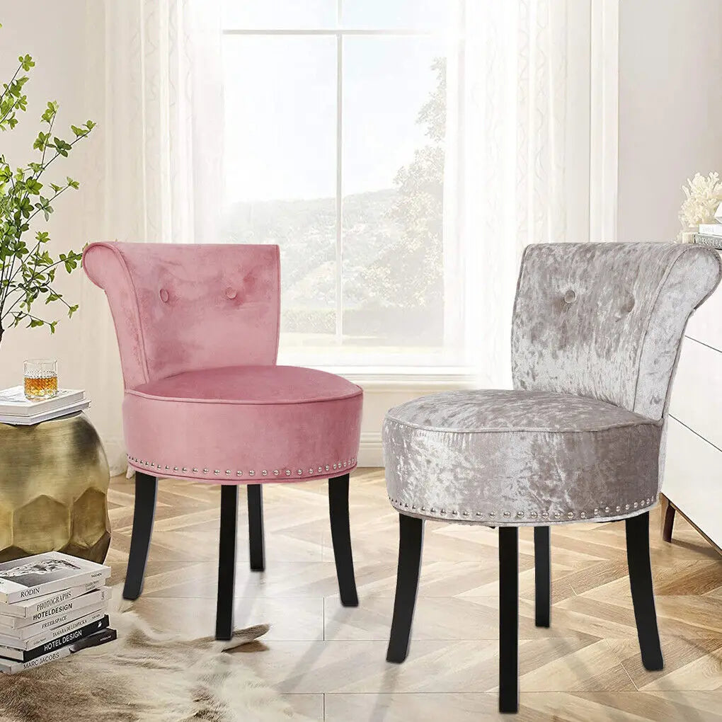 Pink and gray velvet chairs in a room with a window and decorative items.