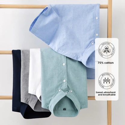 Set of folded shirts in blue, green, and gray hanging on a rack with a label indicating 75% cotton content.