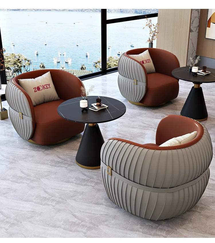 Modern living room with stylish armchairs and a table, featuring ZUO furniture.