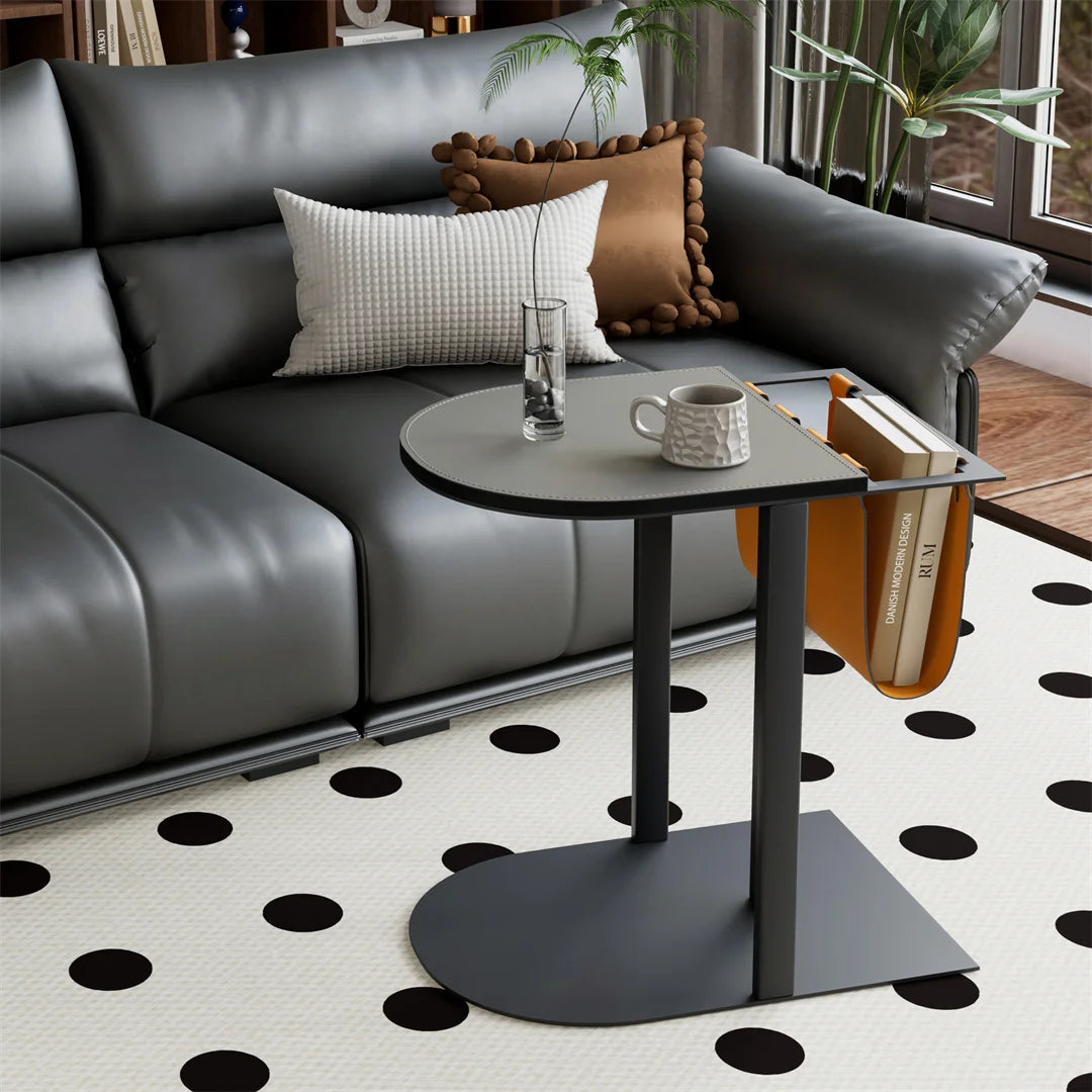 Gray sectional sofa with a small round table in a living room setting.