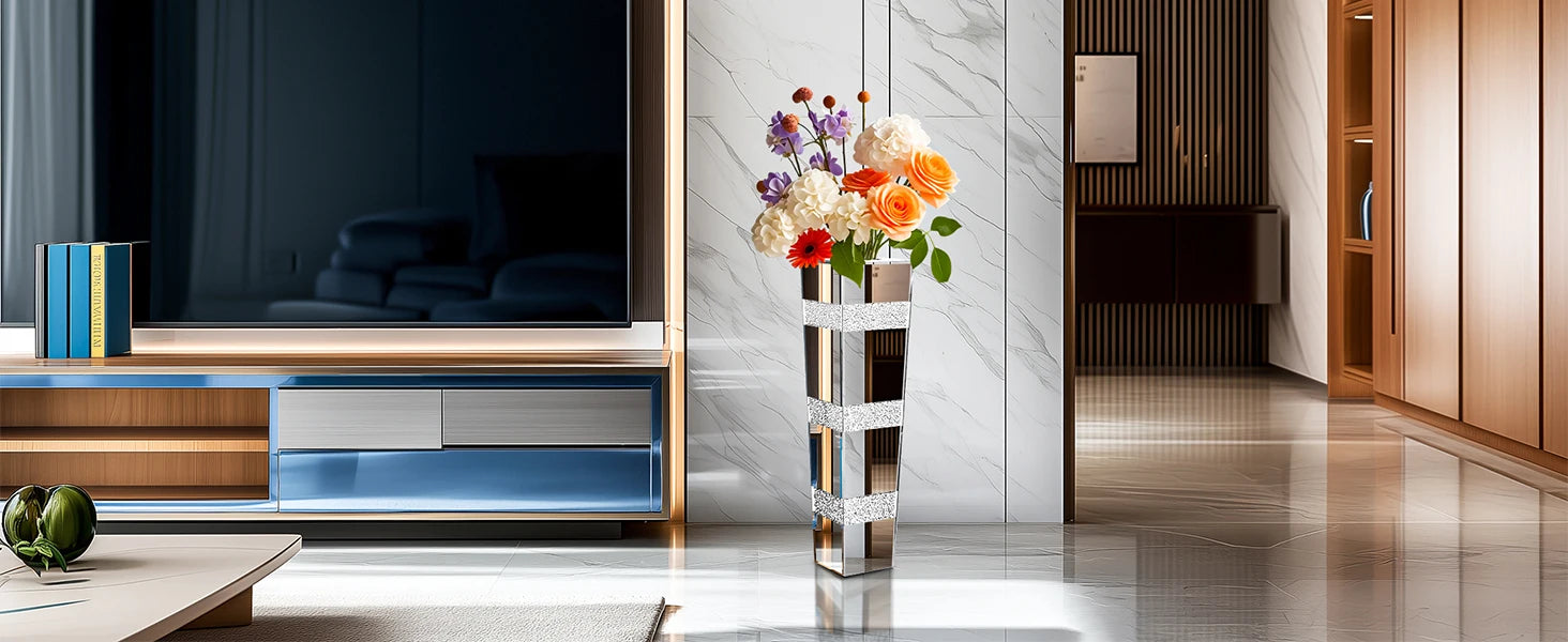 Modern living room with a television, decorative flowers, and a stylish vase.