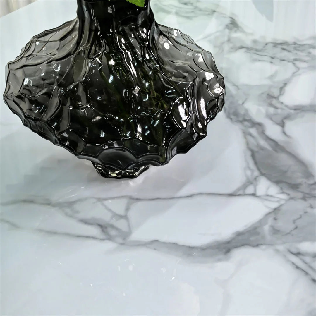 Black glass vase on a marble surface