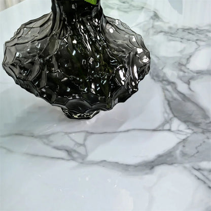 Black glass vase on a marble surface