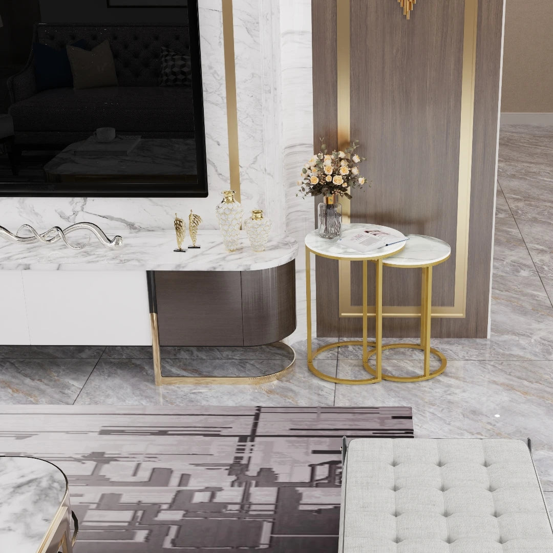 Modern living room with marble fireplace, gold accents, and decorative items.