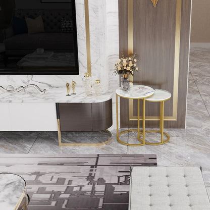 Modern living room with marble fireplace, gold accents, and decorative items.