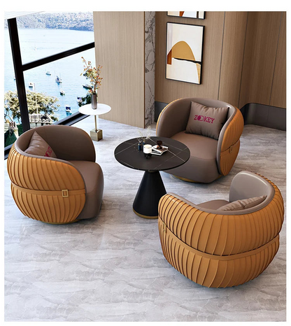 Modern living room with brown and orange chairs and a black coffee table.