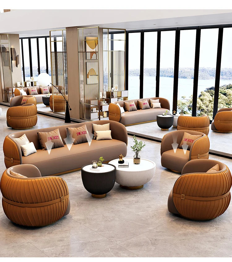 Modern living room with brown and orange furniture and a large window view.