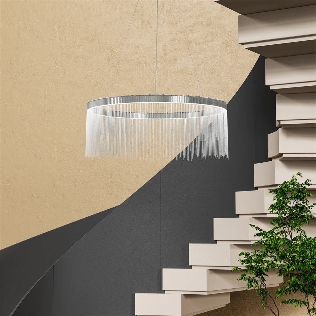 Modern chandelier hanging above a staircase with a neutral wall background