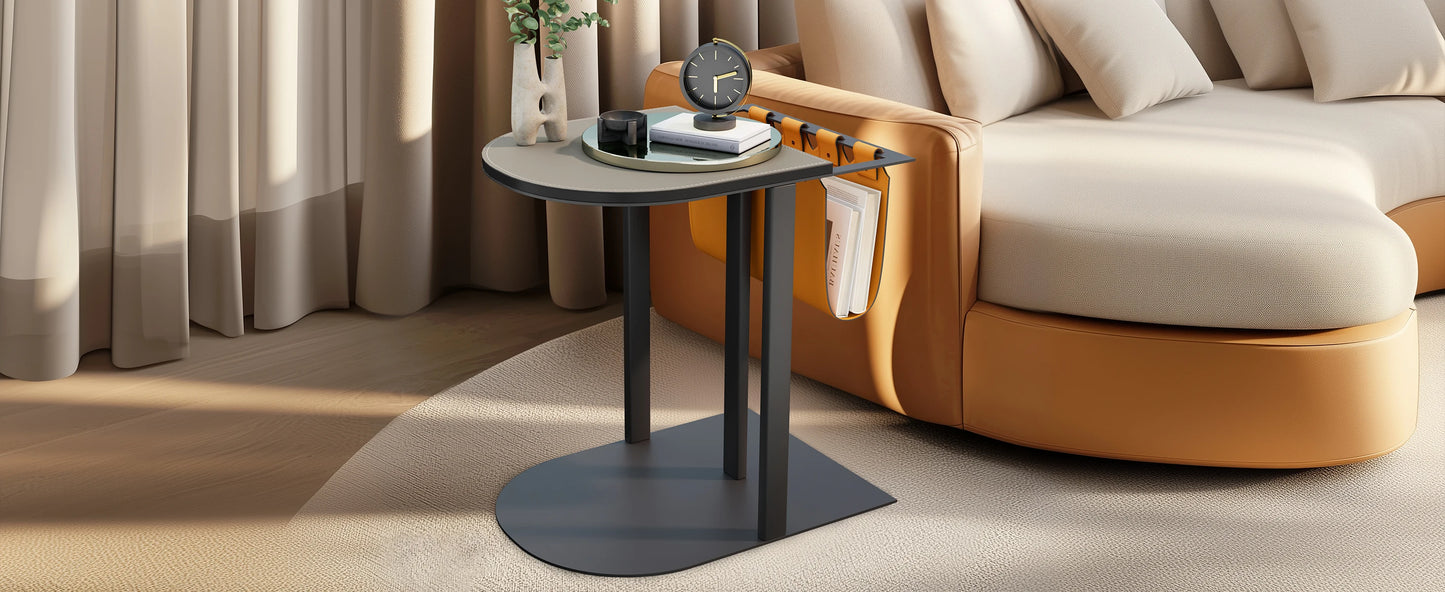 Modern living room with a black side table and beige sofa.