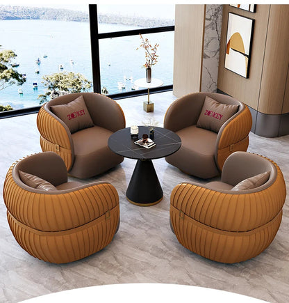 Modern living room with brown and orange chairs and a small round table.