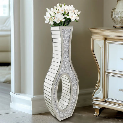 Decorative vase with floral arrangement next to a mirrored cabinet